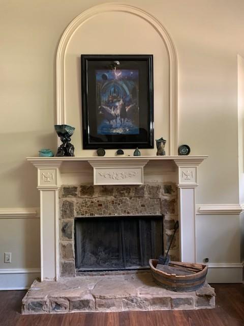 detailed view of a fireplace and wood finished floors