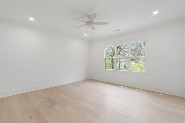 unfurnished room featuring ceiling fan, ornamental molding, and light wood-type flooring