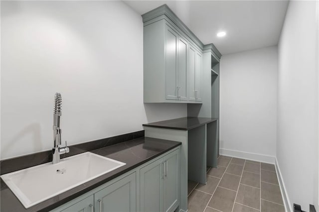 washroom with dark tile patterned floors and sink