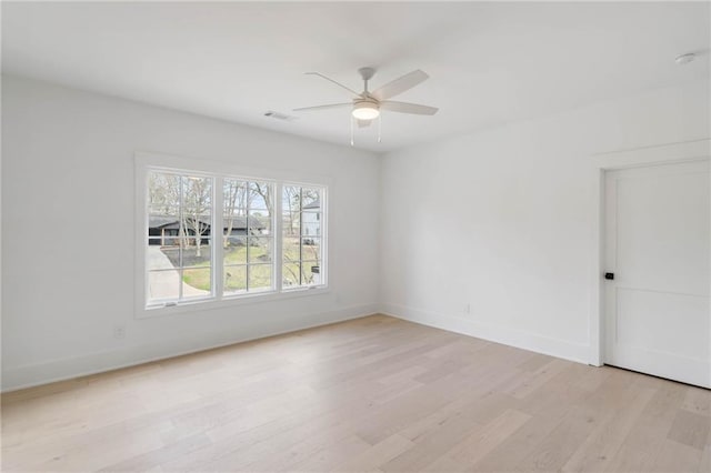 spare room featuring ceiling fan and light hardwood / wood-style flooring