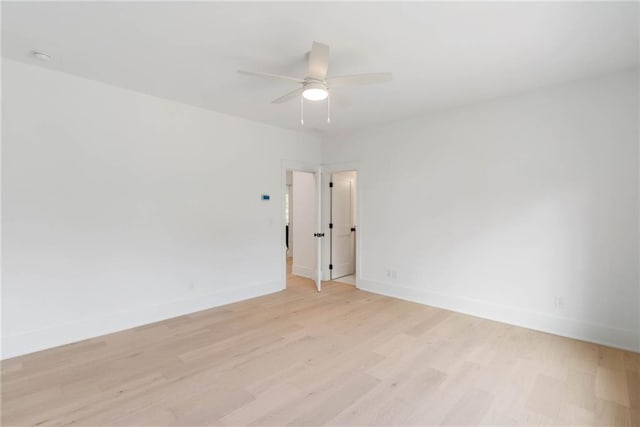 empty room with ceiling fan and light wood-type flooring