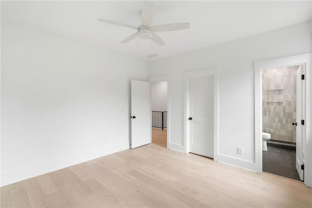 unfurnished bedroom featuring ceiling fan, light hardwood / wood-style flooring, and ensuite bath