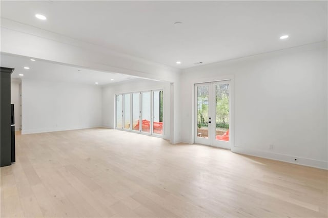 unfurnished room with french doors, crown molding, and light hardwood / wood-style floors