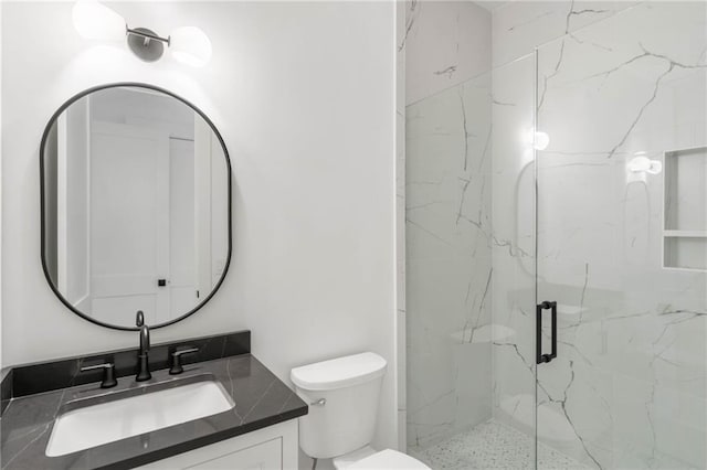 bathroom featuring vanity, toilet, and walk in shower