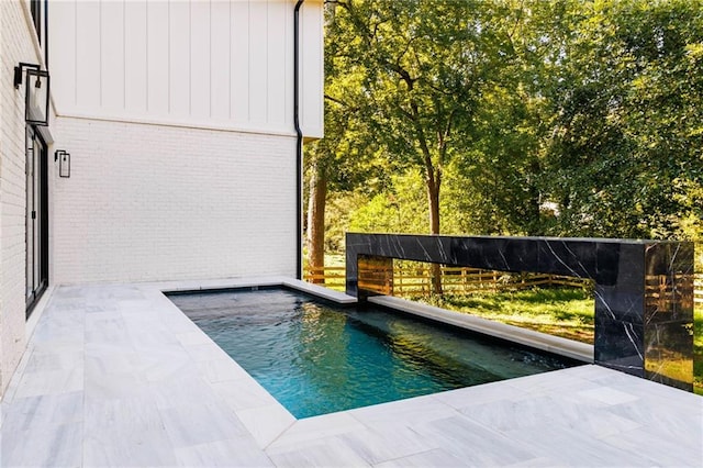 view of swimming pool with a patio area