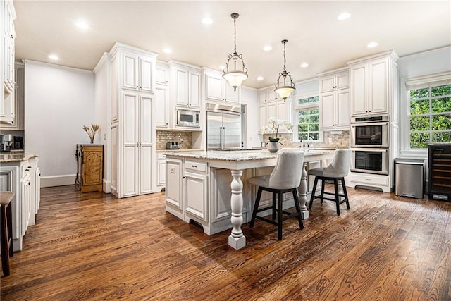 3809 Wieuca Rd NE, Atlanta, GA 30342 - kitchen with built in appliances, dark wood-style floors, recessed lighting, decorative backsplash, and ornamental molding