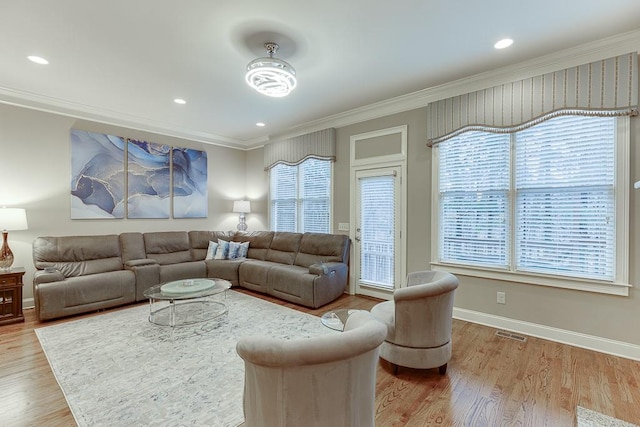 living area with wood finished floors, visible vents, baseboards, recessed lighting, and crown molding