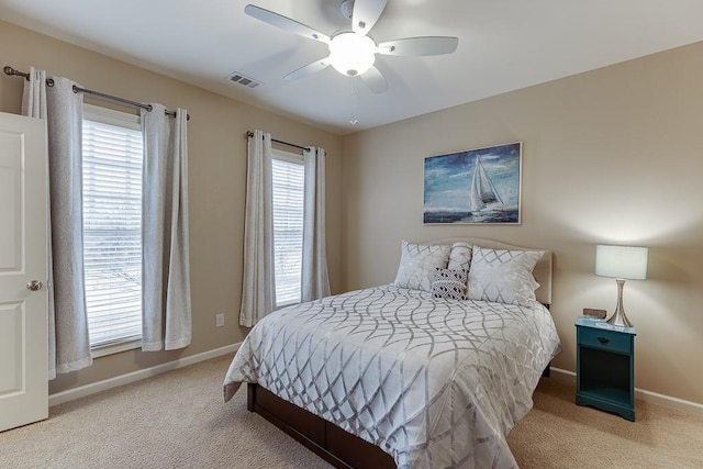 bedroom featuring visible vents, a ceiling fan, baseboards, and carpet floors