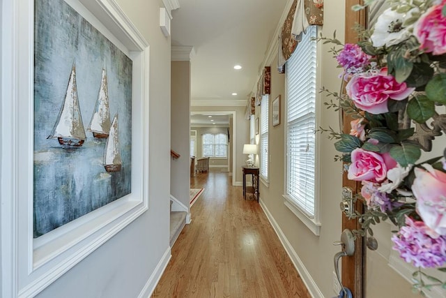 corridor featuring stairway, baseboards, light wood finished floors, recessed lighting, and crown molding