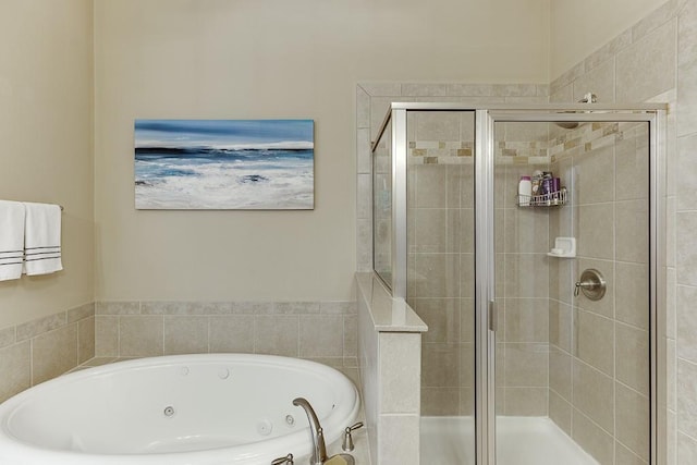 full bath featuring a jetted tub and a stall shower