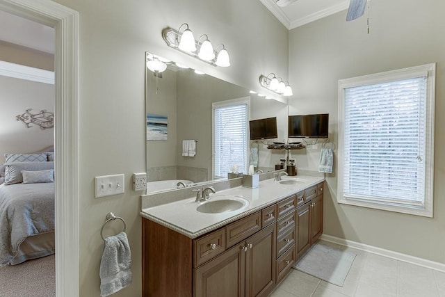 bathroom featuring ornamental molding, connected bathroom, a healthy amount of sunlight, and a sink