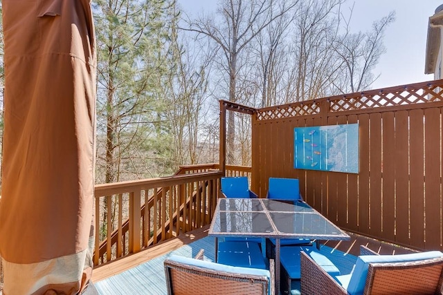 wooden terrace with outdoor dining area