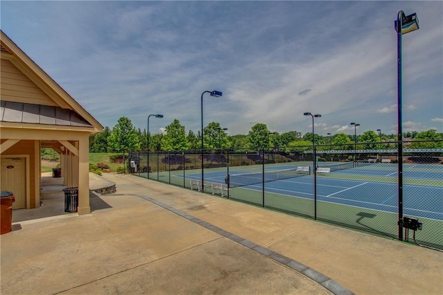 view of tennis court with fence