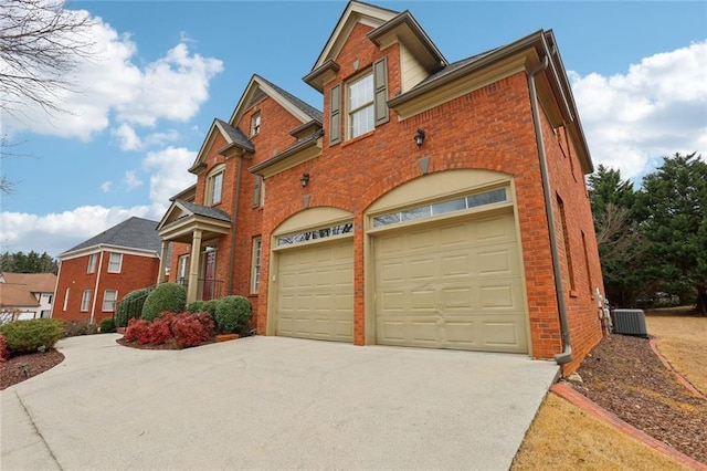 view of front of property with a garage and central AC unit