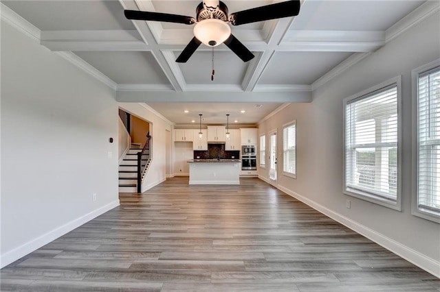1620 Branthaven Ln, Auburn, GA 30011 - unfurnished living room featuring stairway, ceiling fan, coffered ceiling, beam ceiling, and light wood-style floors