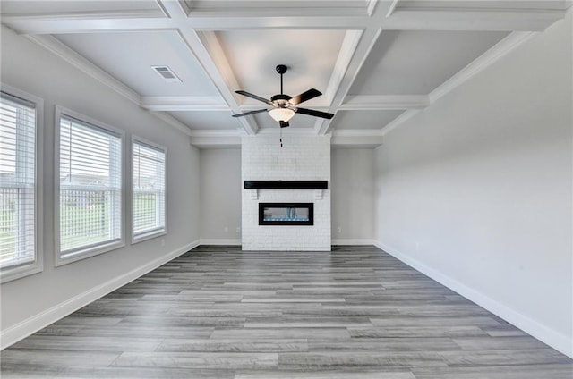 1620 Branthaven Ln, Auburn, GA 30011 - unfurnished living room with wood finished floors, ceiling fan, a large fireplace, coffered ceiling, and beamed ceiling