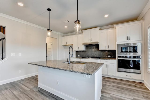 1620 Branthaven Ln, Auburn, GA 30011 - kitchen with appliances with stainless steel finishes, crown molding, stone countertops, decorative backsplash, and white cabinets