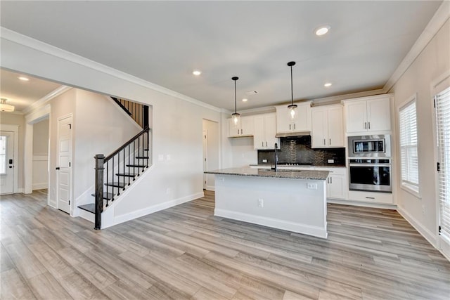 1620 Branthaven Ln, Auburn, GA 30011 - kitchen featuring appliances with stainless steel finishes, white cabinets, crown molding, tasteful backsplash, and light wood-style floors