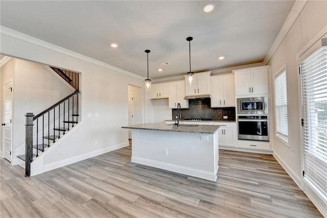 1620 Branthaven Ln, Auburn, GA 30011 - kitchen with appliances with stainless steel finishes, ornamental molding, stone counters, white cabinets, and light wood-style flooring