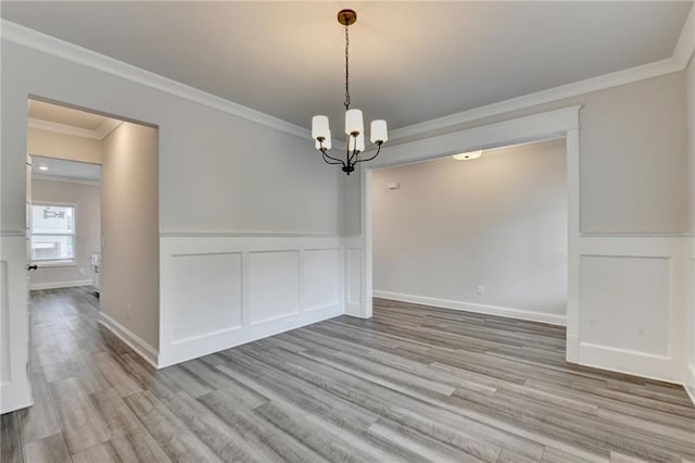 1620 Branthaven Ln, Auburn, GA 30011 - unfurnished dining area with ornamental molding, a chandelier, light wood-style flooring, and wainscoting