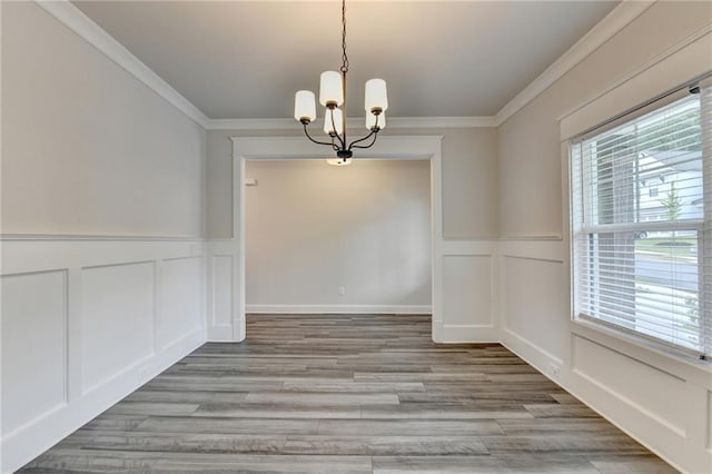 1620 Branthaven Ln, Auburn, GA 30011 - unfurnished dining area featuring a decorative wall, a chandelier, ornamental molding, wainscoting, and light wood-type flooring