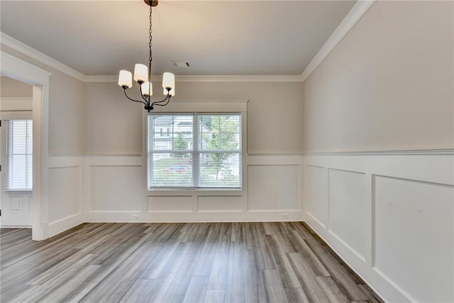 1620 Branthaven Ln, Auburn, GA 30011 - unfurnished room with a decorative wall, a chandelier, wainscoting, wood finished floors, and crown molding