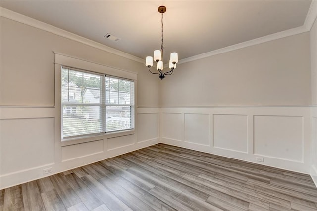 1620 Branthaven Ln, Auburn, GA 30011 - unfurnished room featuring a chandelier, wood finished floors, ornamental molding, a decorative wall, and wainscoting