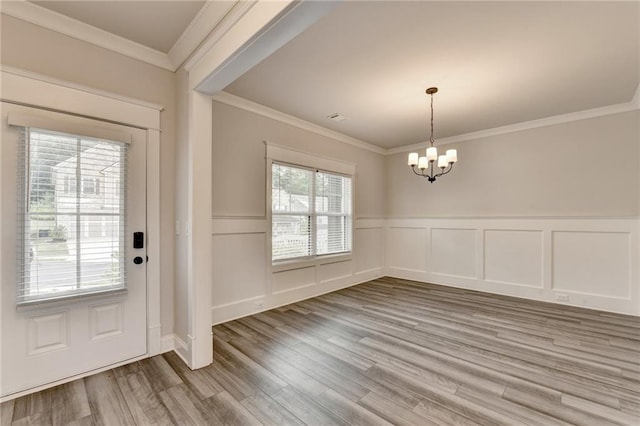 1620 Branthaven Ln, Auburn, GA 30011 - entrance foyer featuring a chandelier, light wood-style floors, a wainscoted wall, ornamental molding, and a decorative wall