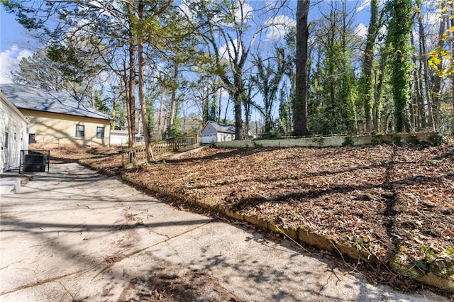 view of yard with fence and central AC