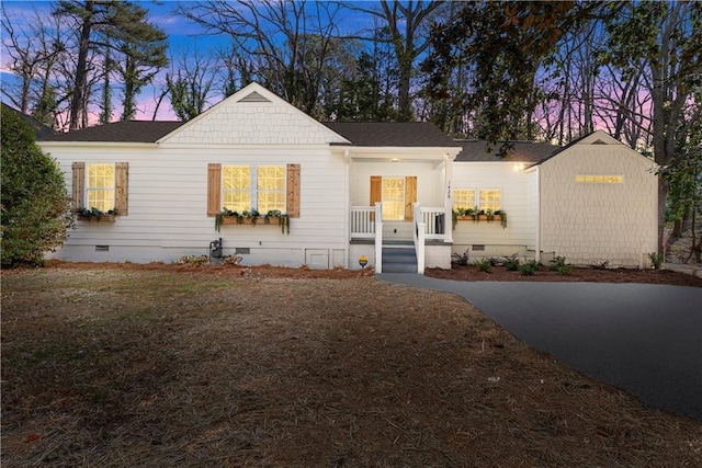 view of front of home with crawl space, a porch, and a shingled roof