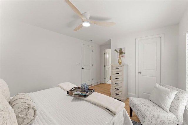 bedroom with light wood-type flooring and a ceiling fan