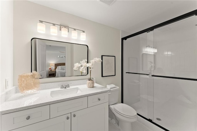 bathroom featuring a stall shower, visible vents, vanity, and toilet