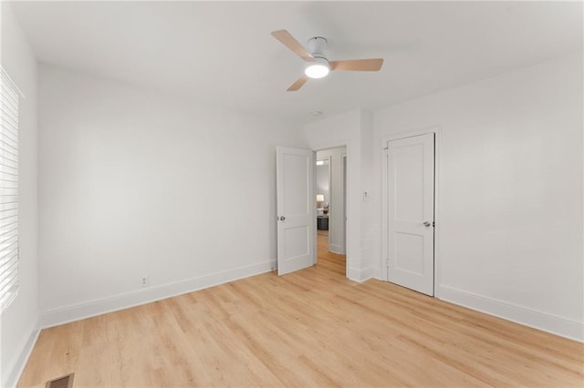 unfurnished bedroom featuring visible vents, multiple windows, light wood-style flooring, and baseboards