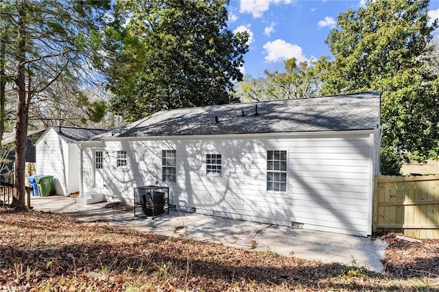 back of property featuring a shingled roof, central AC unit, crawl space, a patio area, and fence