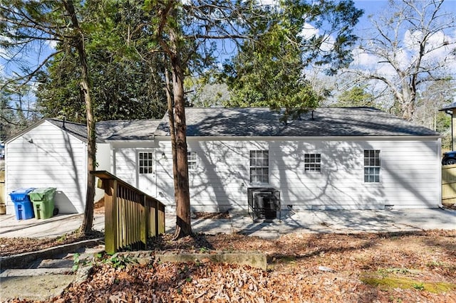 rear view of property with crawl space, a patio area, and central AC unit