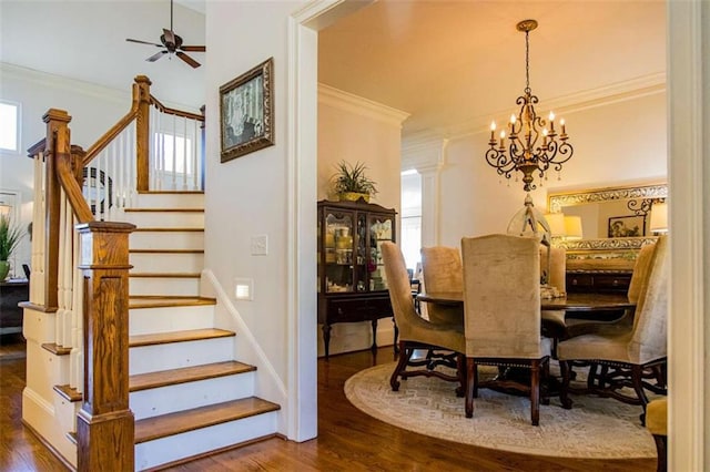 dining space featuring stairs, ornamental molding, and wood finished floors