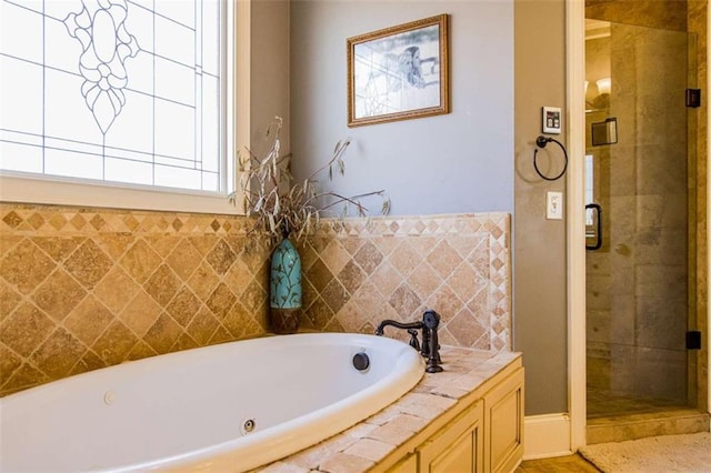 bathroom with a garden tub and a shower stall