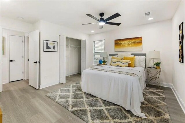 bedroom with ceiling fan, hardwood / wood-style floors, and a closet