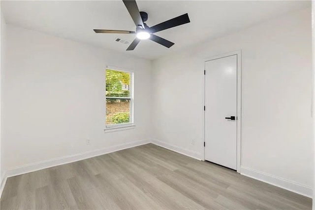 spare room featuring ceiling fan and light hardwood / wood-style floors