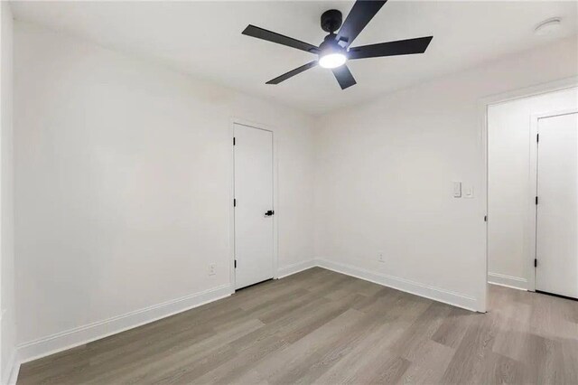 spare room with light hardwood / wood-style flooring and ceiling fan