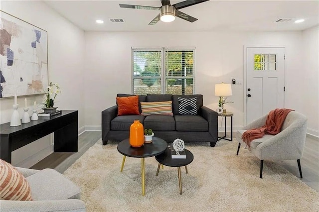 living room with ceiling fan and light hardwood / wood-style flooring