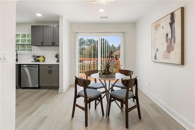 dining space with light hardwood / wood-style floors