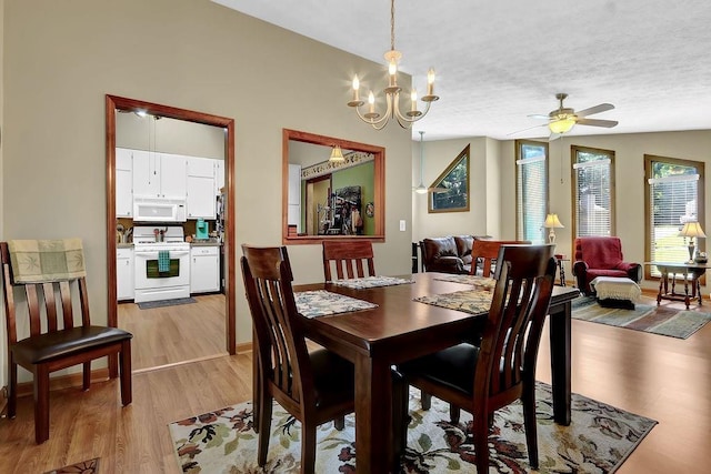 3491 Birchwood Trl, Snellville, GA 30078 - dining room with light wood finished floors, ceiling fan, a chandelier, and a textured ceiling