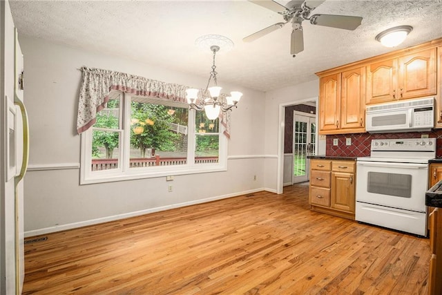5247 Yeager Rd, Douglasville, GA 30135 - kitchen featuring white appliances, light wood finished floors, a chandelier, backsplash, and baseboards