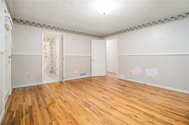 5247 Yeager Rd, Douglasville, GA 30135 - unfurnished bedroom with crown molding, wood finished floors, a textured ceiling, baseboards, and ensuite bath