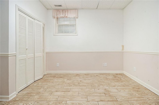 5247 Yeager Rd, Douglasville, GA 30135 - unfurnished bedroom featuring wood finished floors, a closet, a drop ceiling, and baseboards