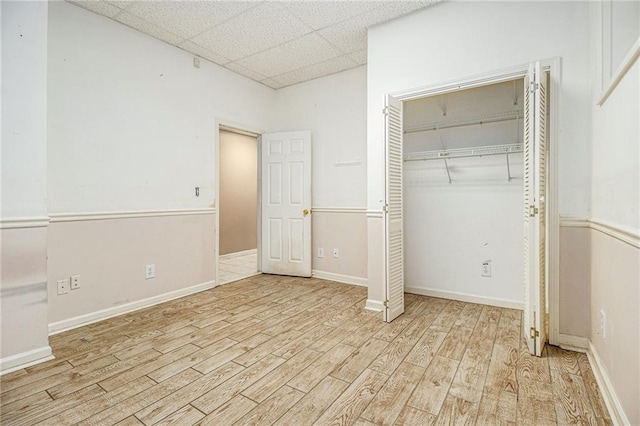 5247 Yeager Rd, Douglasville, GA 30135 - unfurnished bedroom featuring wood finished floors, a paneled ceiling, a closet, and baseboards