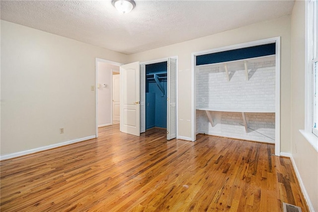 5247 Yeager Rd, Douglasville, GA 30135 - unfurnished bedroom featuring wood finished floors, a textured ceiling, and baseboards