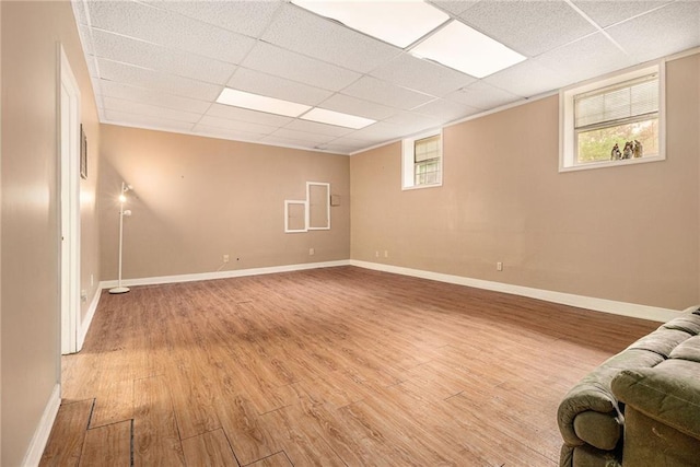 5247 Yeager Rd, Douglasville, GA 30135 - basement with light wood-style floors, a paneled ceiling, and baseboards