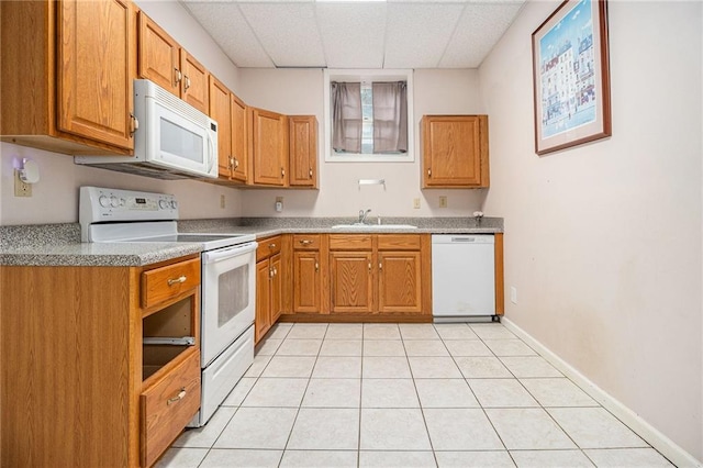 5247 Yeager Rd, Douglasville, GA 30135 - kitchen with white appliances, a sink, light tile patterned floors, a drop ceiling, and brown cabinets